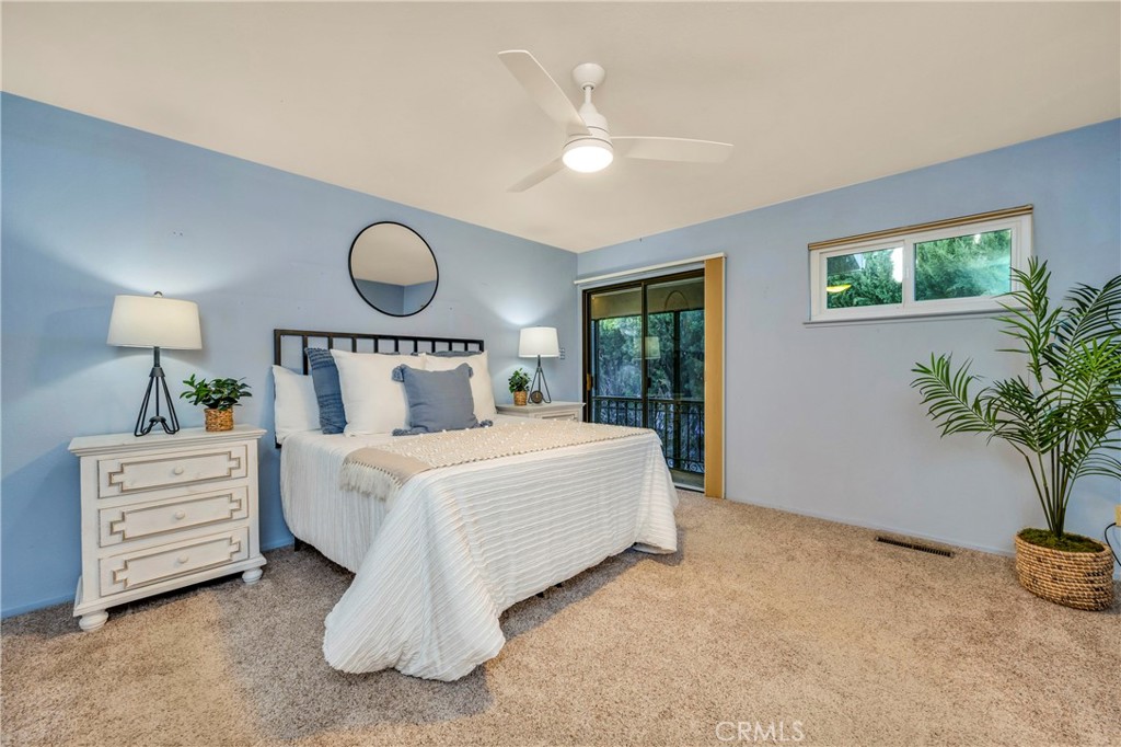 7723 Cora Drive Lucerne, CA 95458 - Photo 16 of 56 a bedroom with a bed and a potted plant