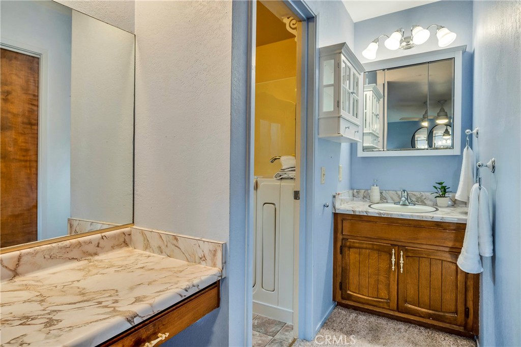 7723 Cora Drive Lucerne, CA 95458 - Photo 17 of 56 a bathroom with a granite countertop sink and a mirror