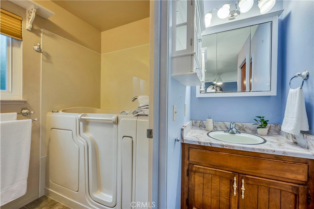 7723 Cora Drive Lucerne, CA 95458 - Photo 18 of 56 a bathroom with a granite countertop sink and a mirror