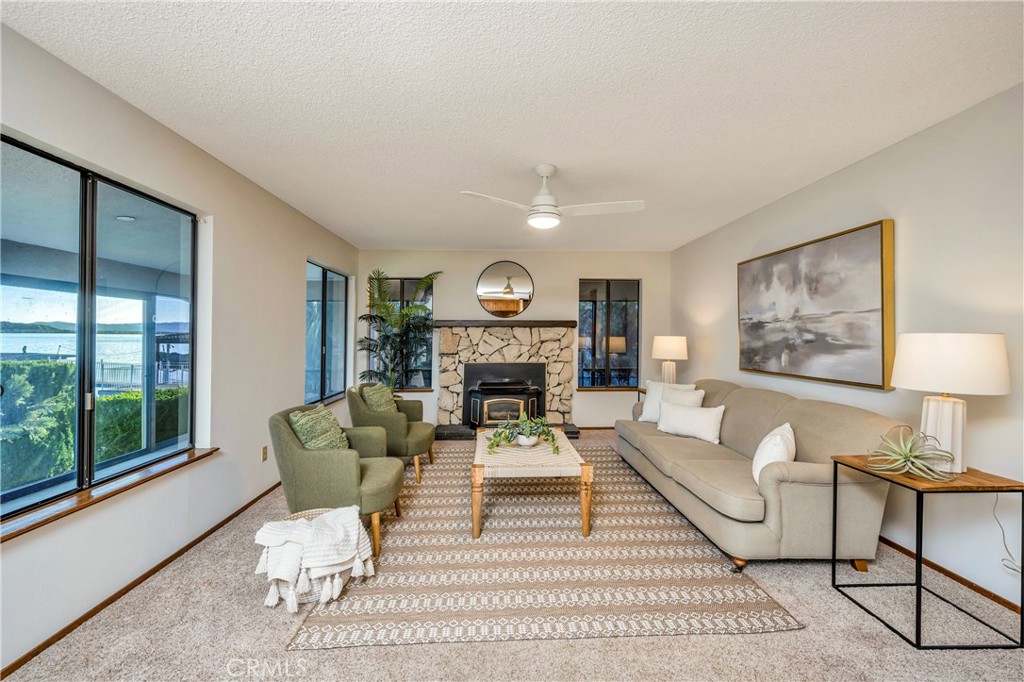 7723 Cora Drive Lucerne, CA 95458 - Photo 23 of 56 a living room with furniture a fireplace and a large window