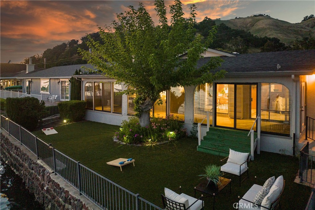 7723 Cora Drive Lucerne, CA 95458 - Photo 41 of 56 a view of a house with backyard sitting area and garden