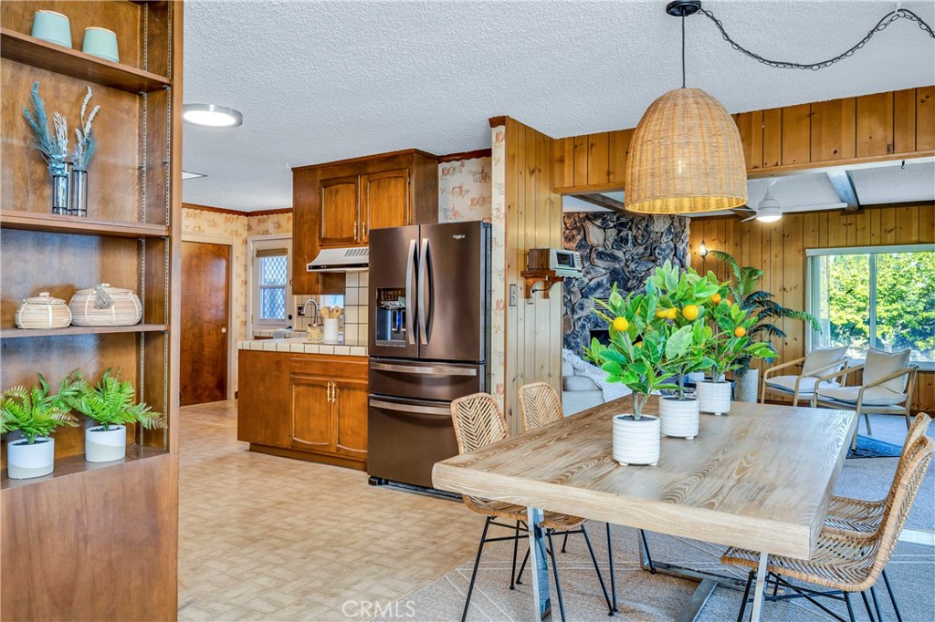 7723 Cora Drive Lucerne, CA 95458 - Photo 7 of 56 a dining room with furniture potted plants and wooden floor