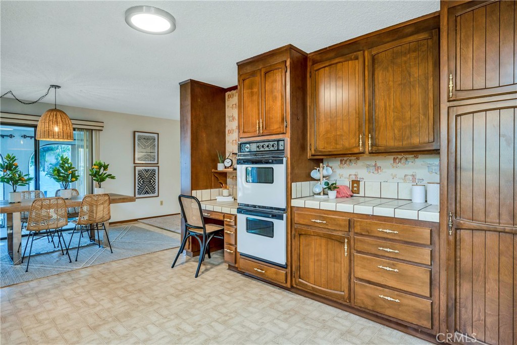 7723 Cora Drive Lucerne, CA 95458 - Photo 9 of 56 a kitchen with stainless steel appliances granite countertop a refrigerator and wooden cabinets