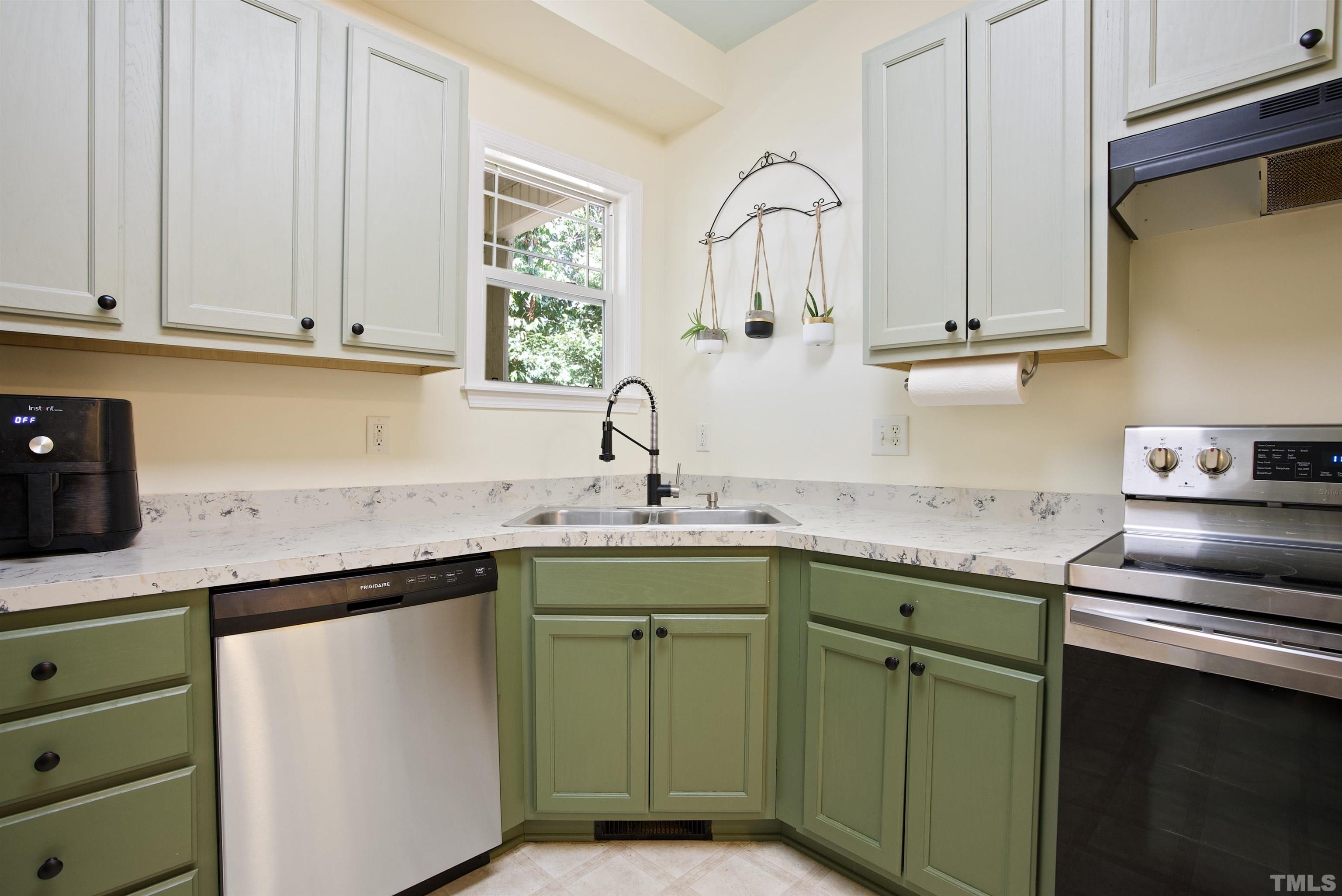 3421 Suncrest Village Lane Raleigh, NC 27616 - Photo 11 of 29 a kitchen with cabinets a sink and appliances