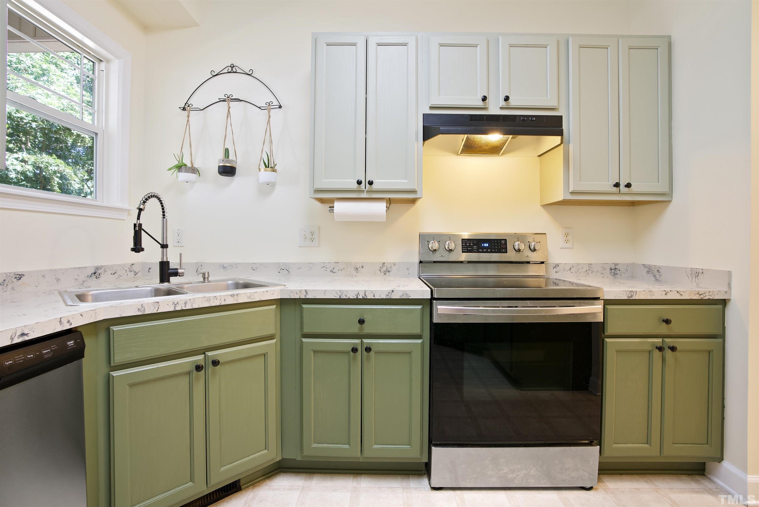 3421 Suncrest Village Lane Raleigh, NC 27616 - Photo 13 of 29 a kitchen with granite countertop a sink stainless steel appliances and cabinets