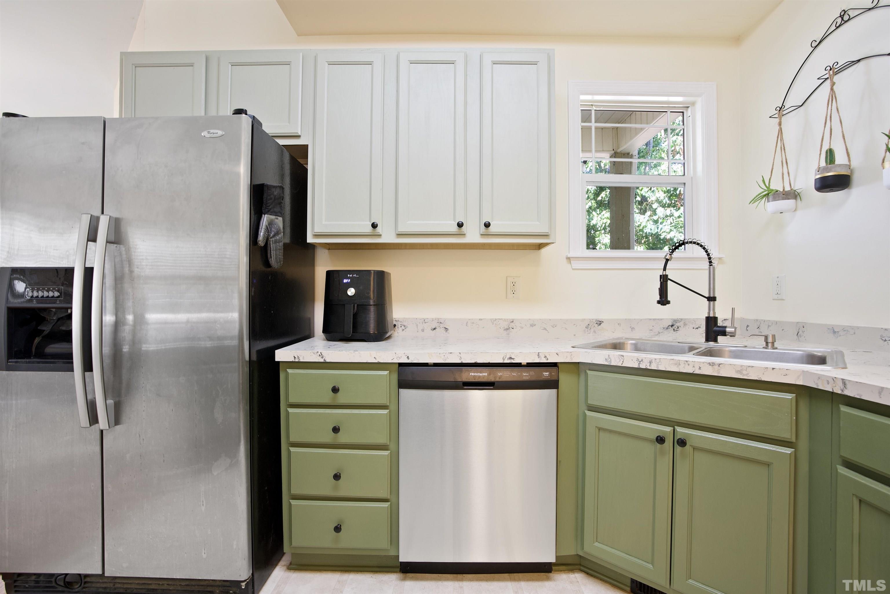3421 Suncrest Village Lane Raleigh, NC 27616 - Photo 14 of 29 a kitchen with a refrigerator sink and cabinets