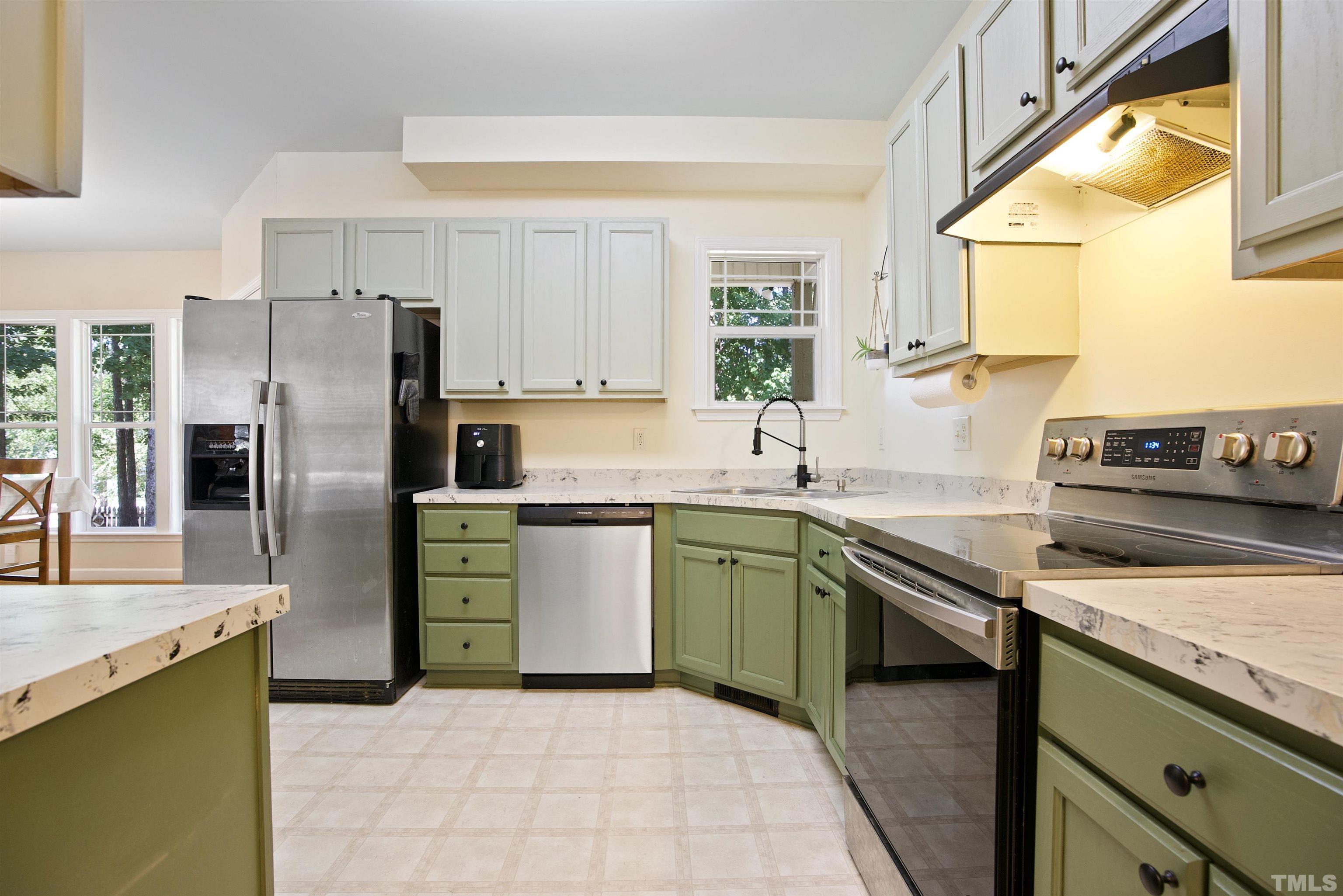 3421 Suncrest Village Lane Raleigh, NC 27616 - Photo 15 of 29 a kitchen with stainless steel appliances granite countertop a sink stove and refrigerator