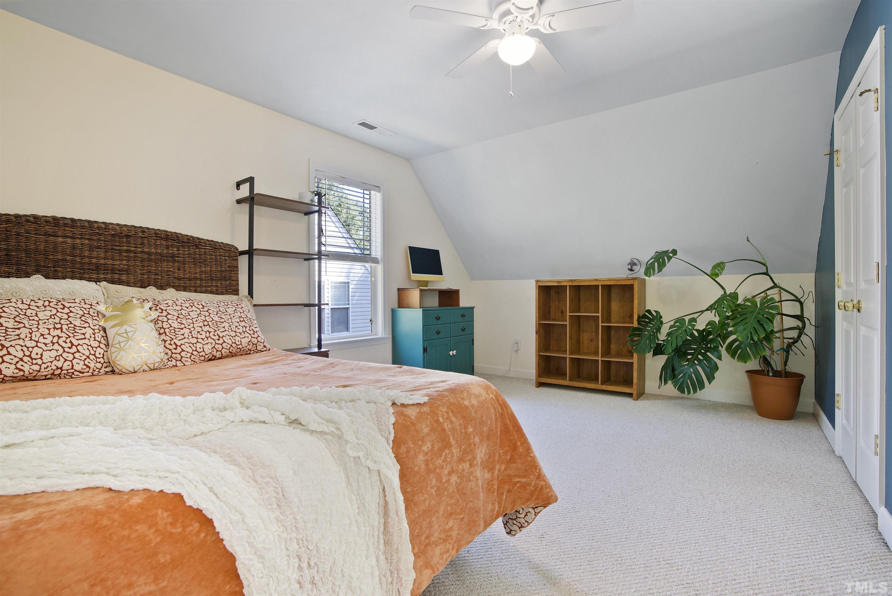 3421 Suncrest Village Lane Raleigh, NC 27616 - Photo 23 of 29 a bedroom with a large bed and potted plant