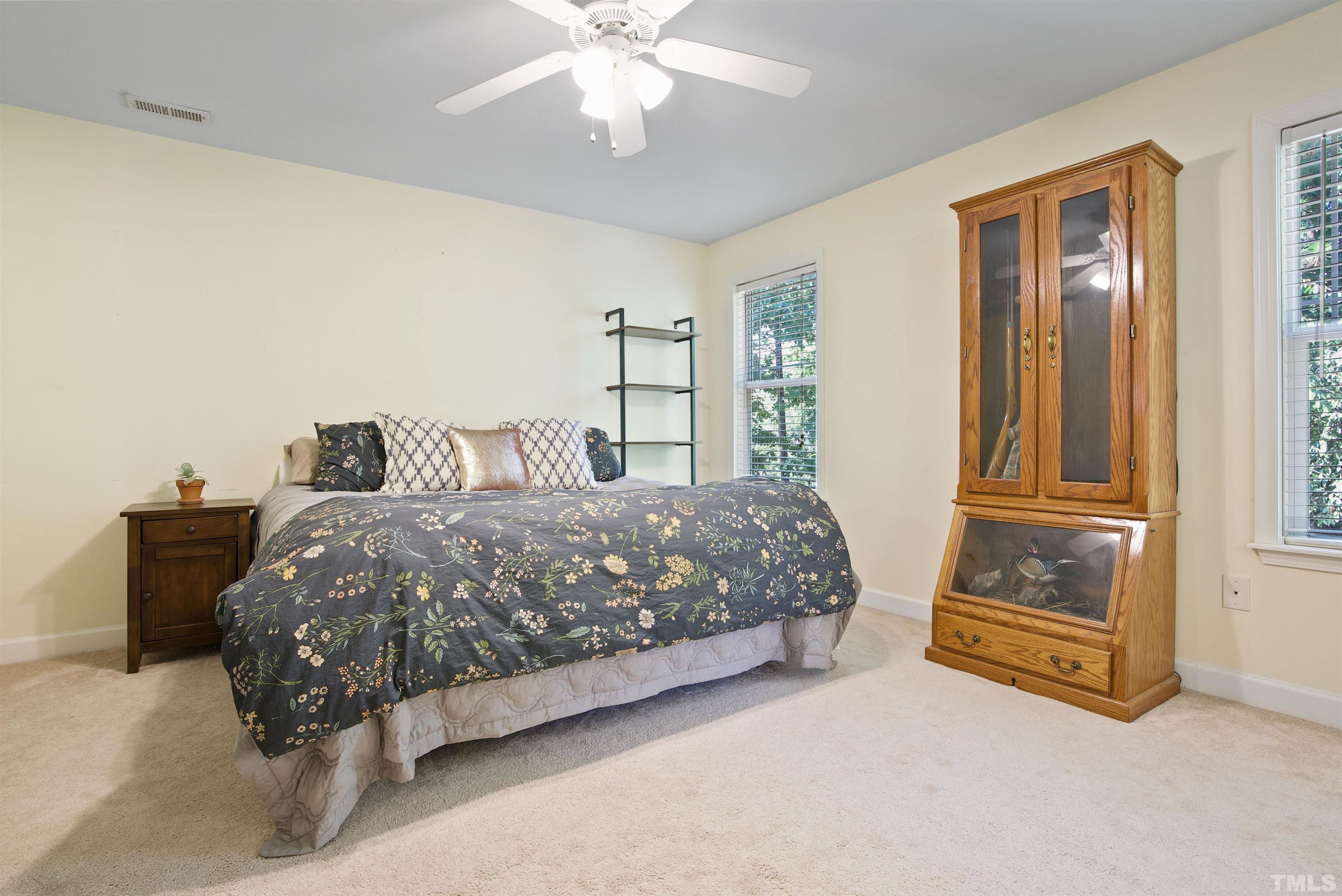 3421 Suncrest Village Lane Raleigh, NC 27616 - Photo 24 of 29 a bedroom with a bed and wooden floor