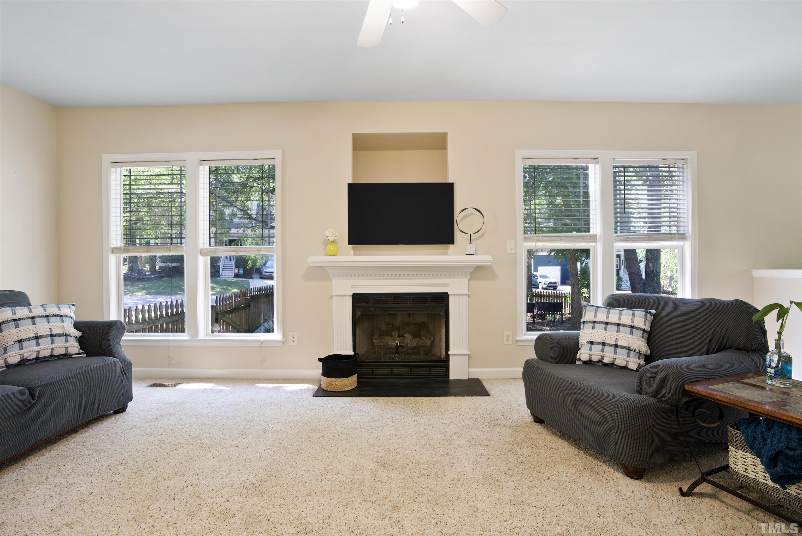 3421 Suncrest Village Lane Raleigh, NC 27616 - Photo 7 of 29 a living room with furniture a fireplace and a flat screen tv