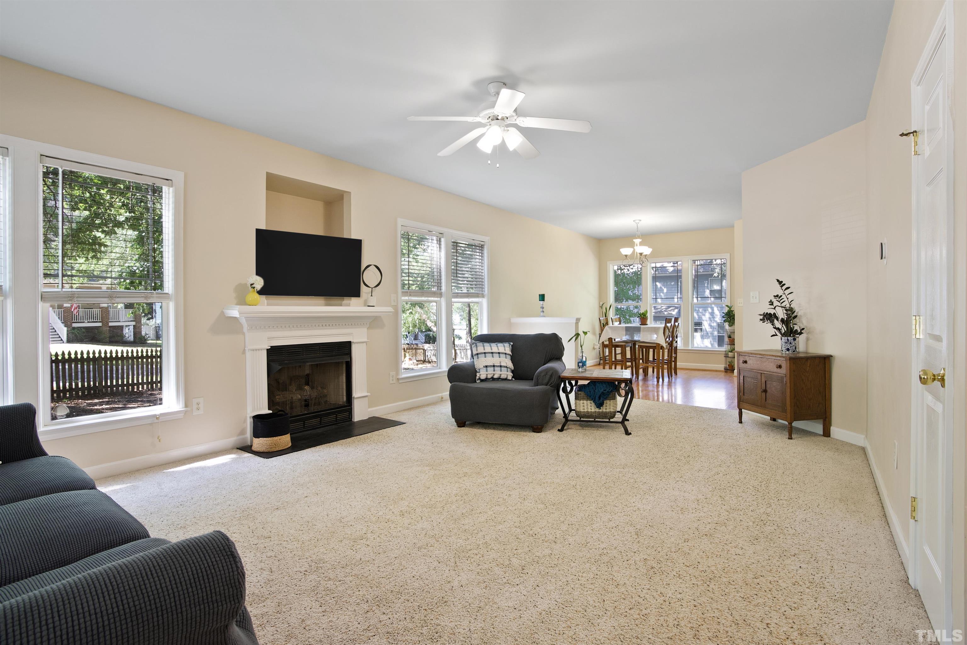 3421 Suncrest Village Lane Raleigh, NC 27616 - Photo 8 of 29 a living room with furniture a fireplace and a flat screen tv