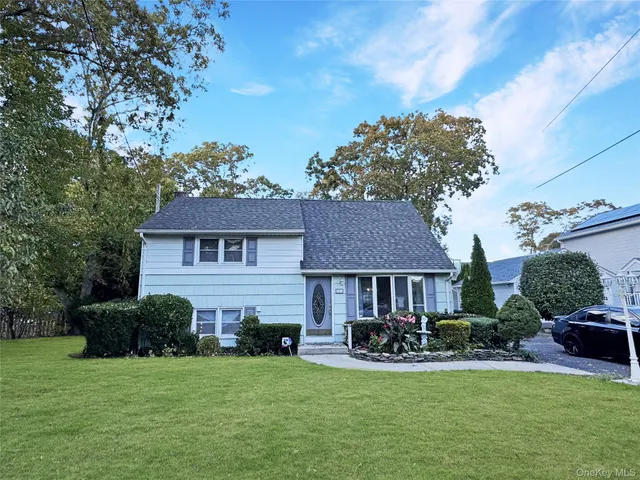 a view of a house with a yard porch and sitting area