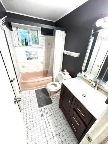a bathroom with a sink a toilet a tub and shower