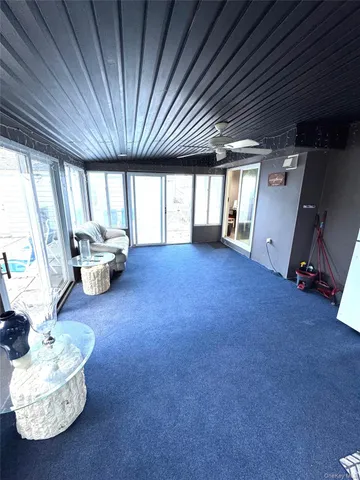 a view of livingroom with furniture and large windows