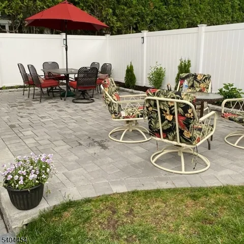 a view of a chairs and table in backyard