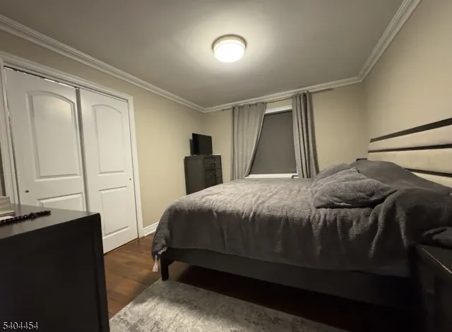 a bedroom with a bed and a mirror