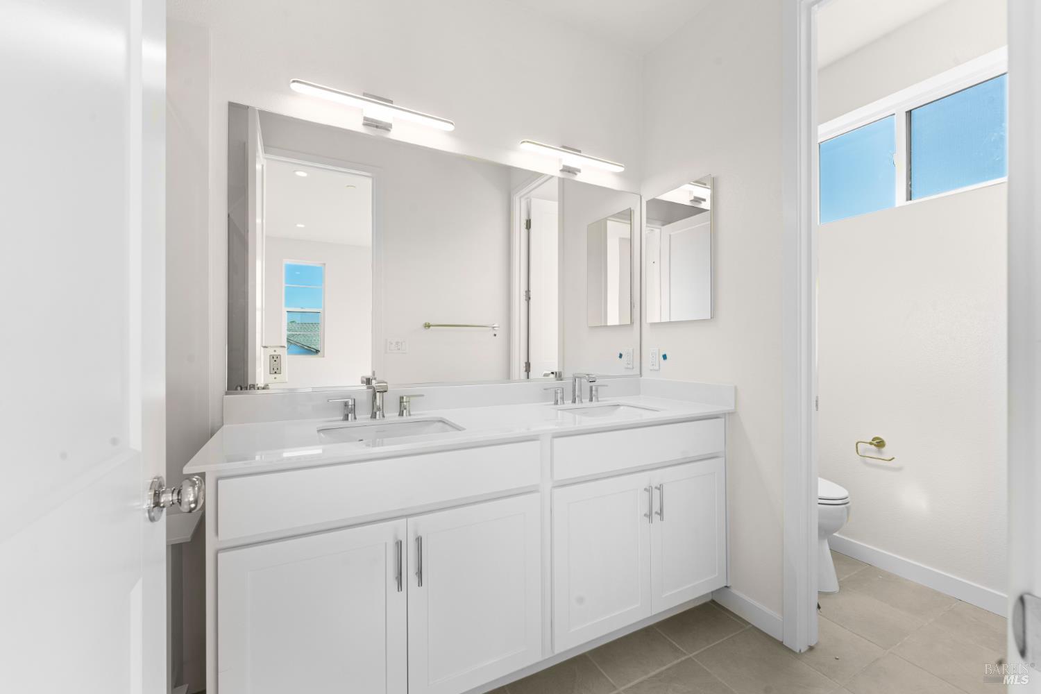 1448 Waterside Lane Rohnert Park, CA 94928 - Photo 21 of 35 a bathroom with a double vanity sink and mirror