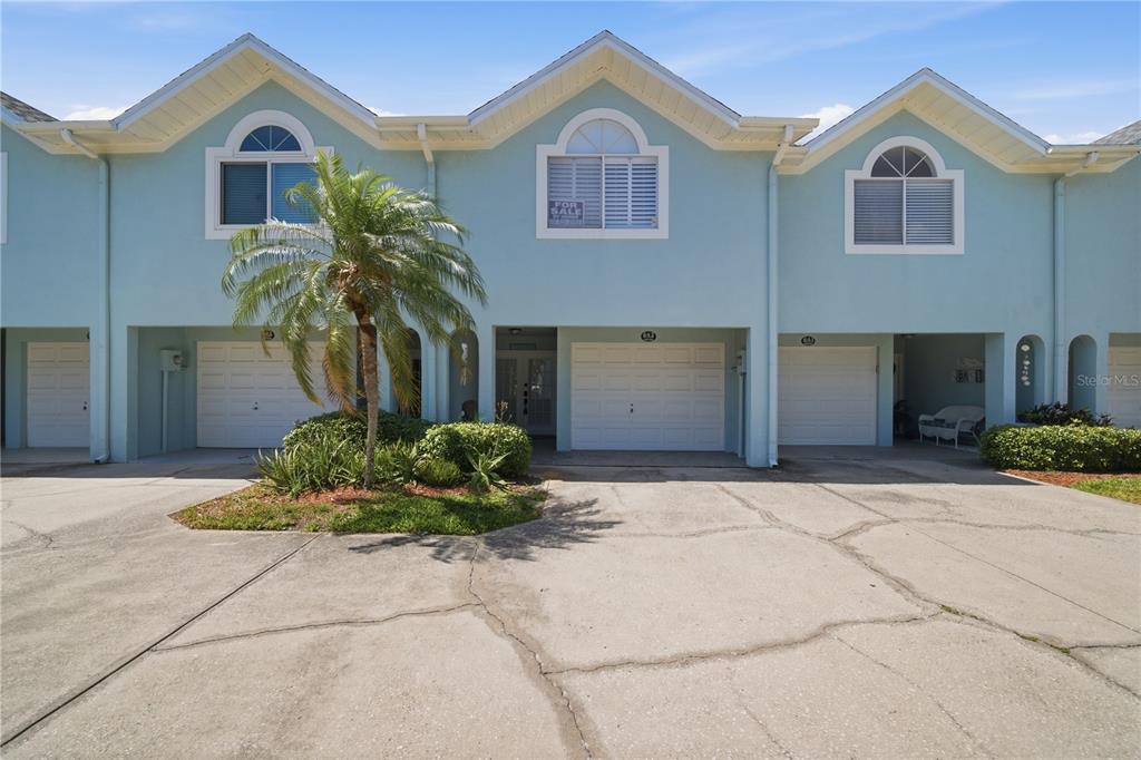 643 Garland Circle Indian Rocks Beach, FL 33785 - Photo 2 of 81 a front view of a house with garden