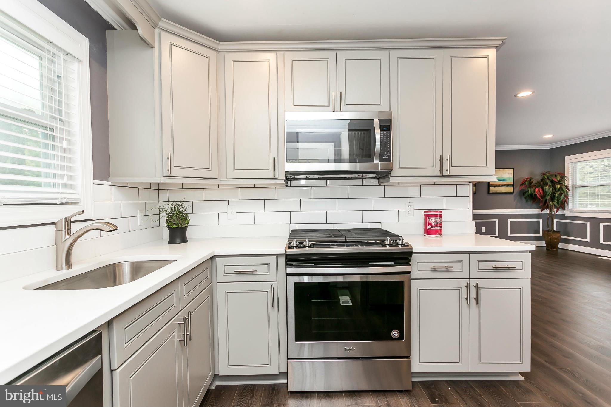 200 Highfalcon Road Reisterstown, MD 21136 - Photo 11 of 28 a kitchen with cabinets stainless steel appliances and sink
