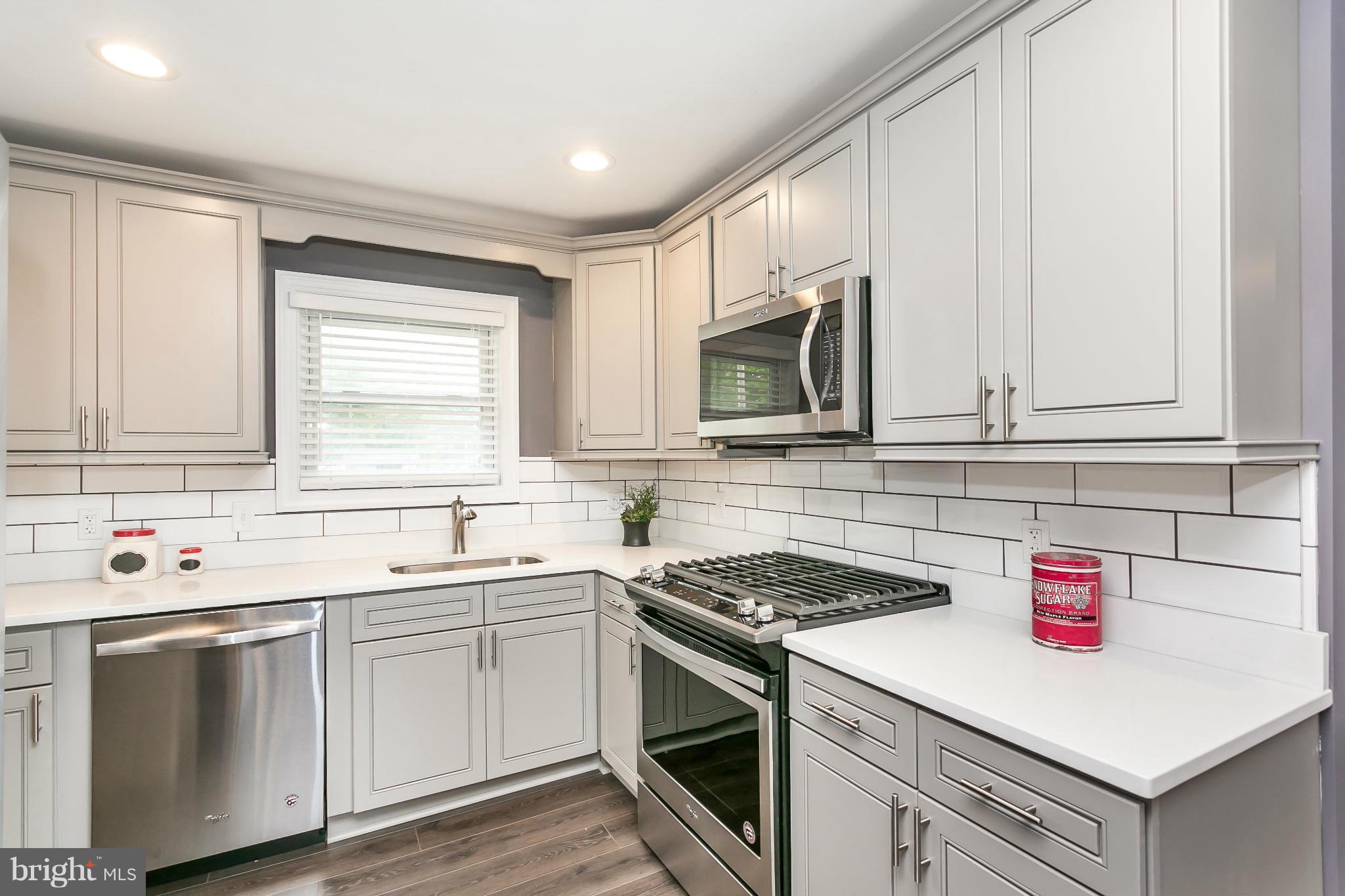 200 Highfalcon Road Reisterstown, MD 21136 - Photo 9 of 28 a kitchen with a sink stove top oven and cabinets