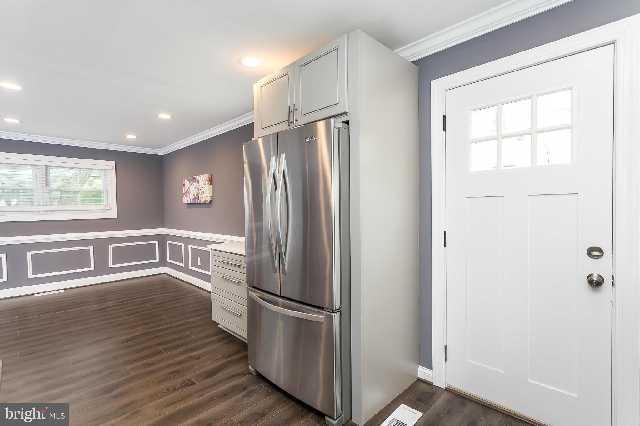 200 Highfalcon Road Reisterstown, MD 21136 - Photo 10 of 28 a kitchen with stainless steel appliances a refrigerator and wooden floor