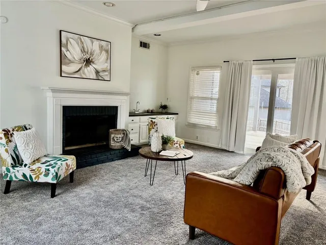 a view of a house with a yard and sitting area