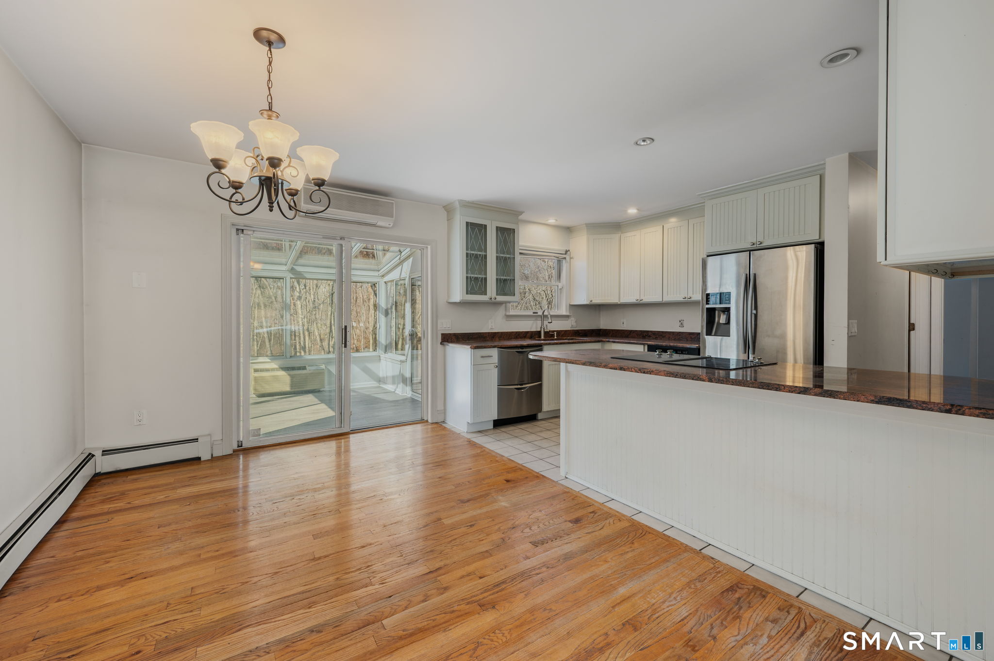 5 Windy Ridge Place, Unit 5 Waterford, CT 06385 - Photo 12 of 37 a large kitchen with stainless steel appliances granite countertop a refrigerator a oven a stove and a wooden floors