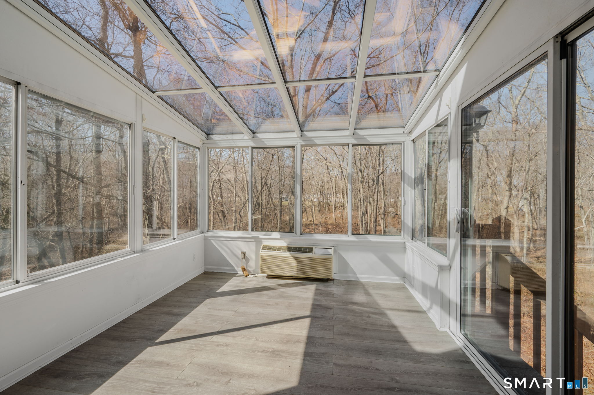 5 Windy Ridge Place, Unit 5 Waterford, CT 06385 - Photo 15 of 37 a large white room with a large window and furniture