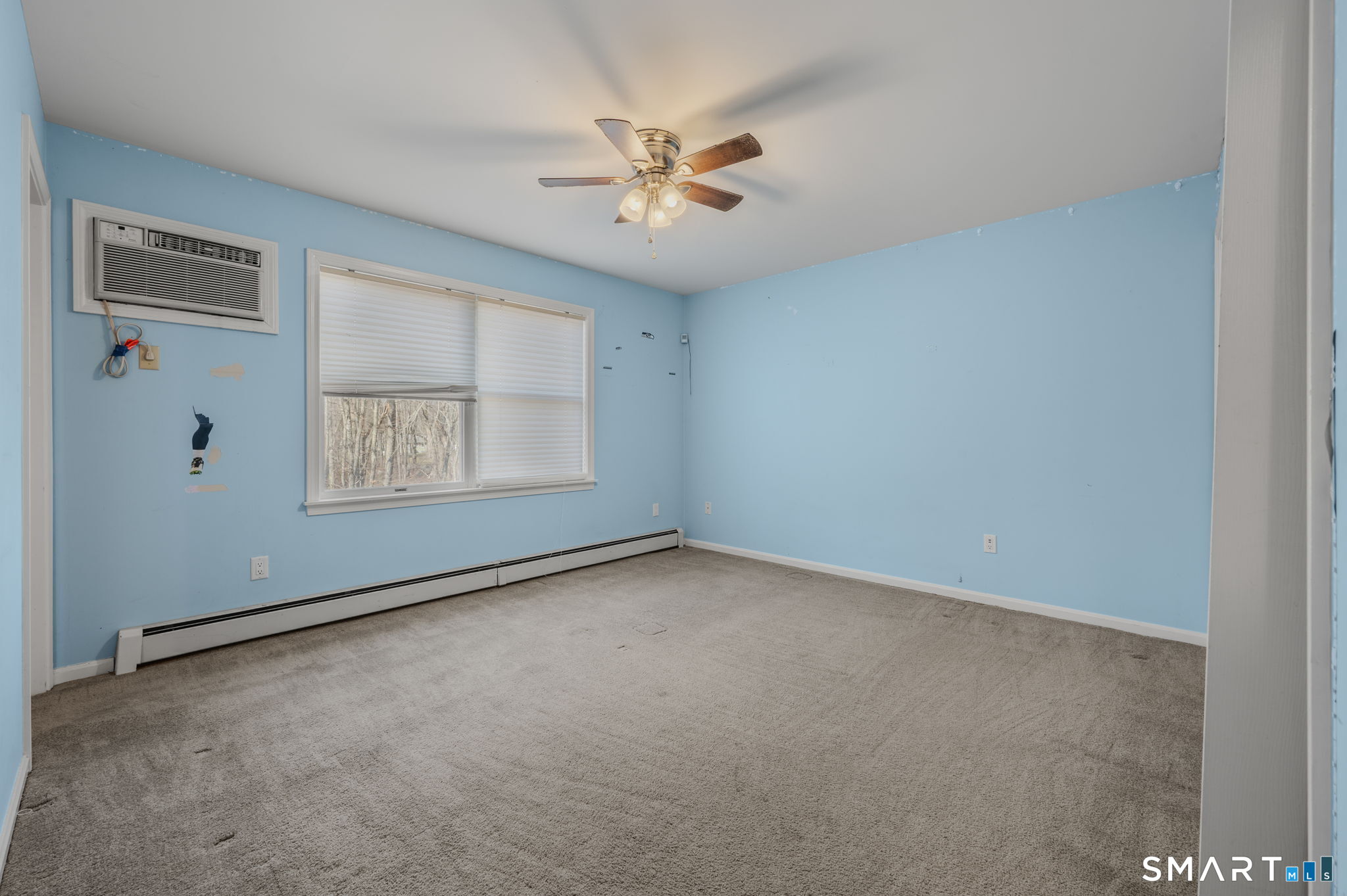 5 Windy Ridge Place, Unit 5 Waterford, CT 06385 - Photo 17 of 37 an empty room with windows and fan