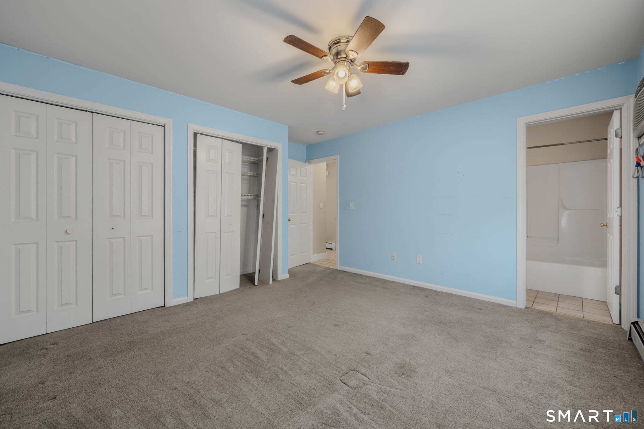 5 Windy Ridge Place, Unit 5 Waterford, CT 06385 - Photo 19 of 37 an empty room with closet and a ceiling fan