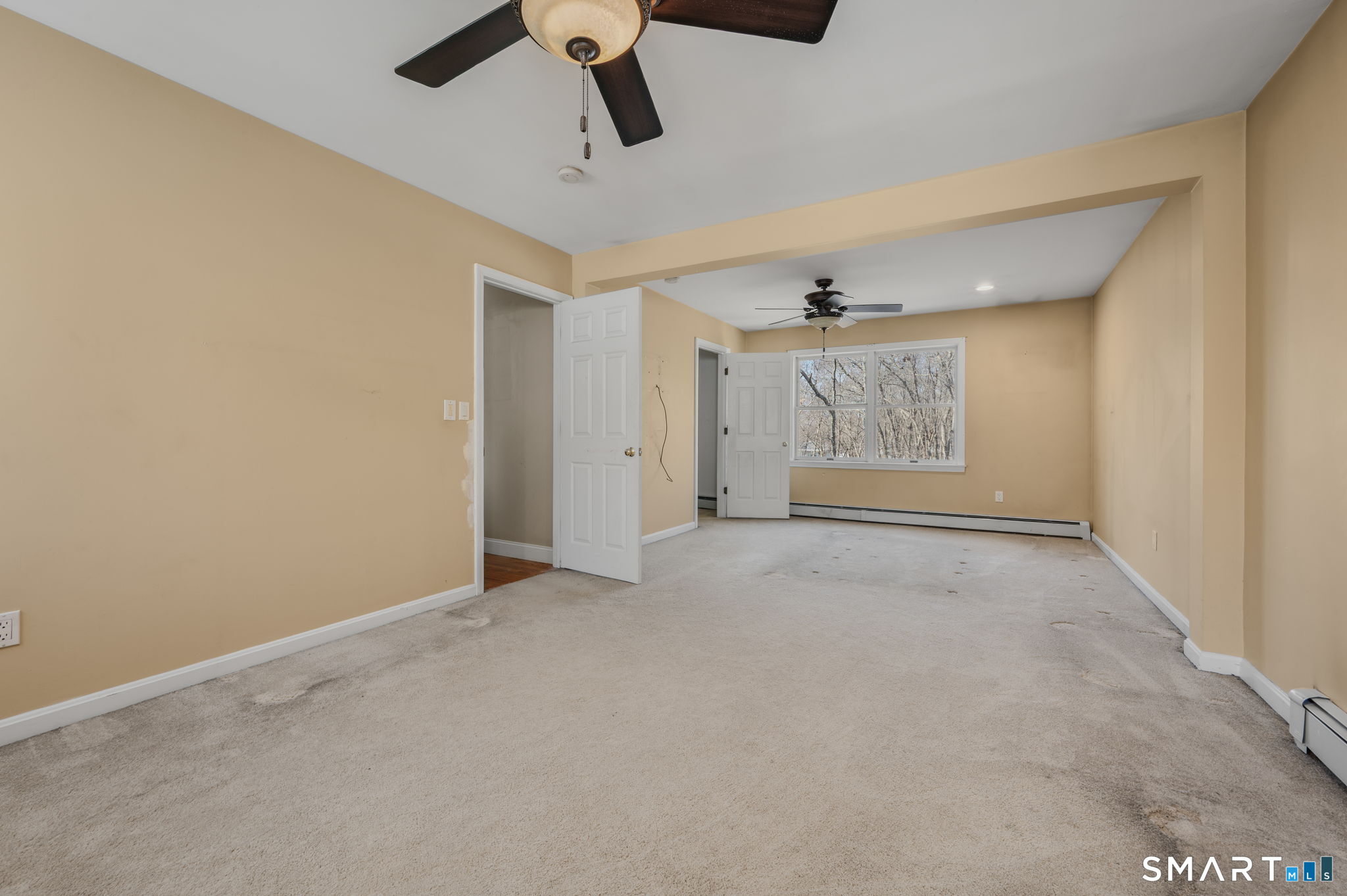 5 Windy Ridge Place, Unit 5 Waterford, CT 06385 - Photo 24 of 37 an empty room with windows and ceiling fan