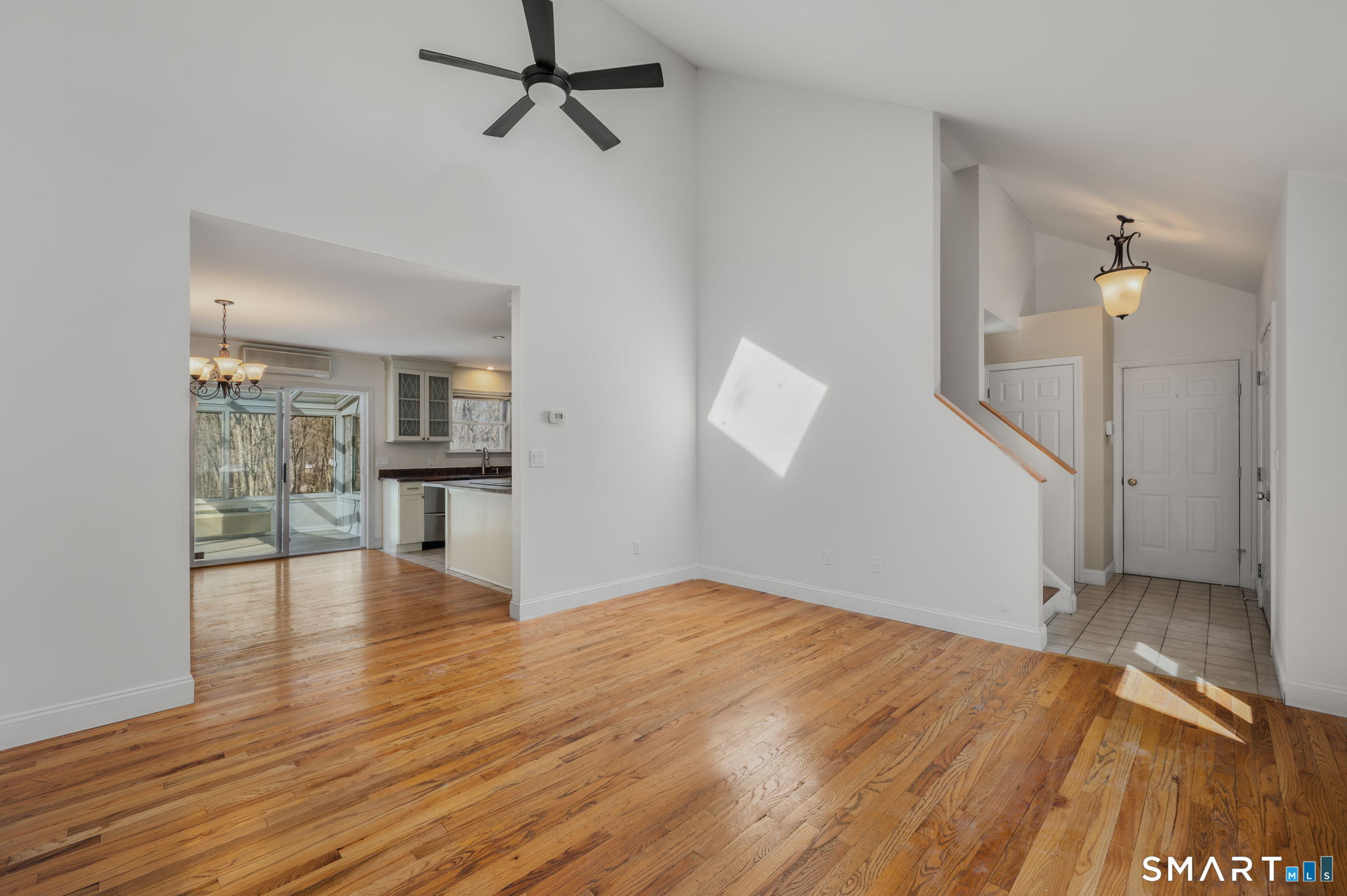 5 Windy Ridge Place, Unit 5 Waterford, CT 06385 - Photo 3 of 37 wooden floor in an empty room with a window