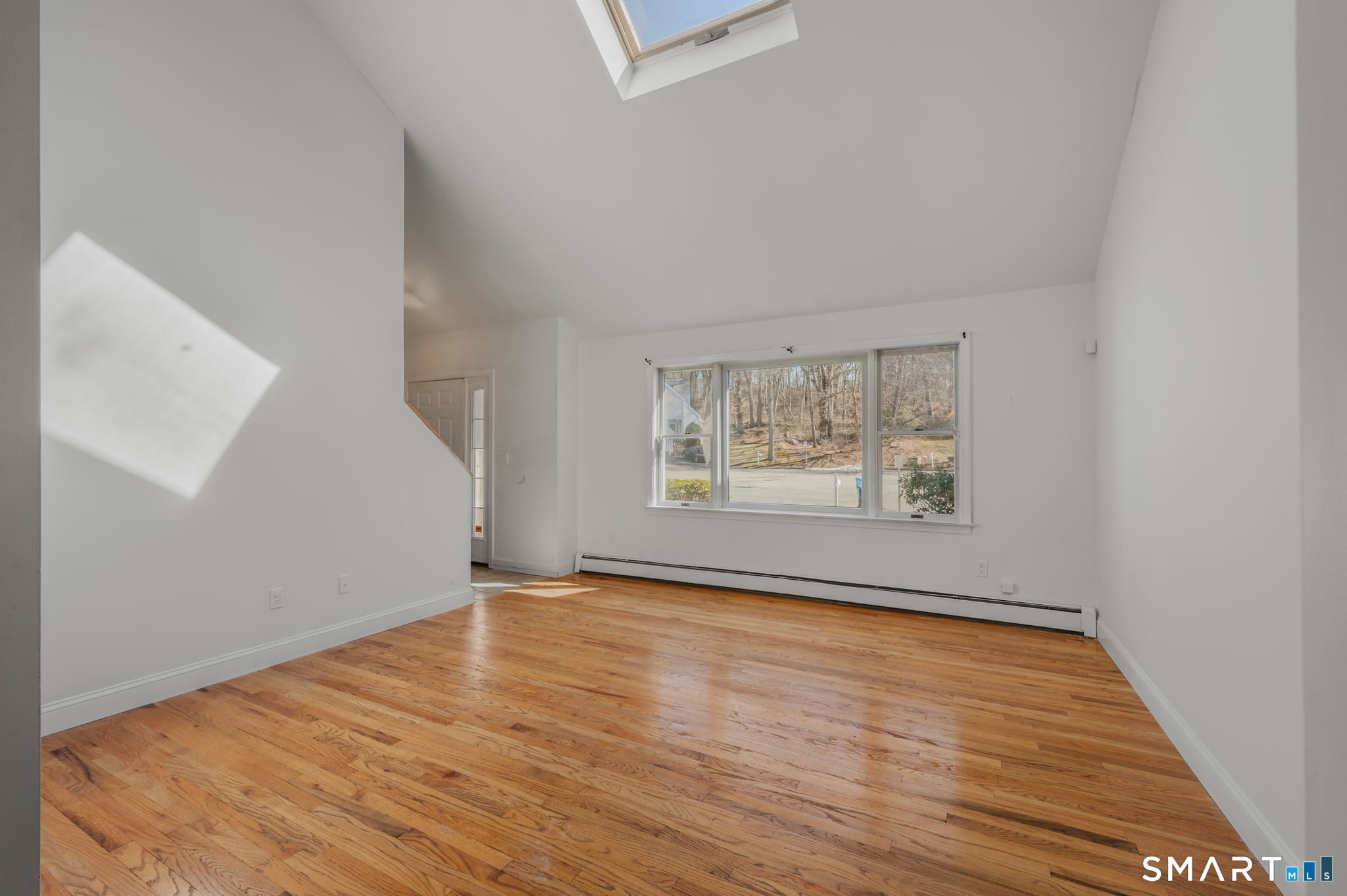 5 Windy Ridge Place, Unit 5 Waterford, CT 06385 - Photo 5 of 37 an empty room with wooden floor and window