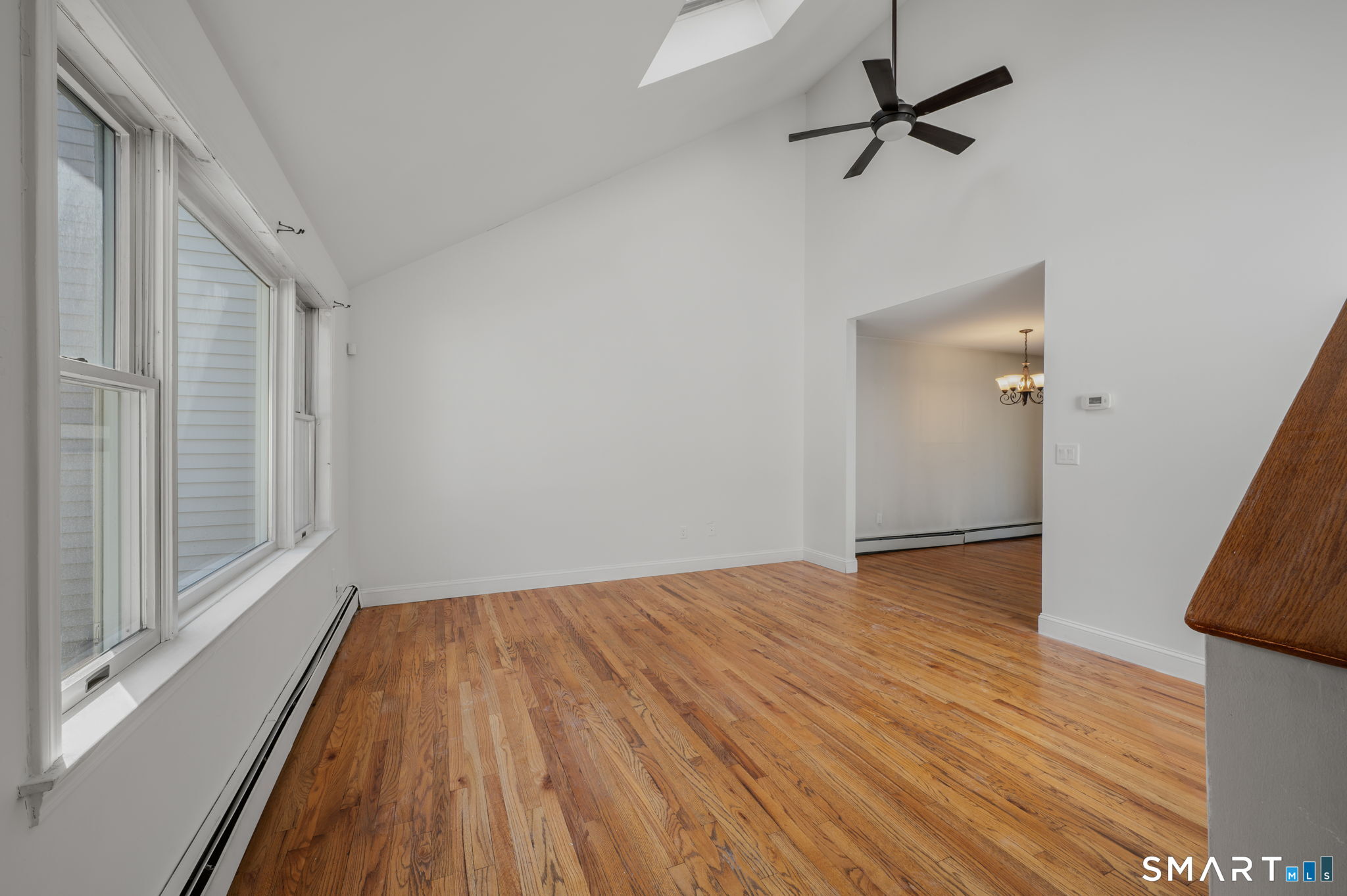 5 Windy Ridge Place, Unit 5 Waterford, CT 06385 - Photo 7 of 37 a view of empty room with wooden floor and fan