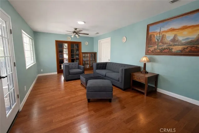 a living room with furniture and a painting on the wall