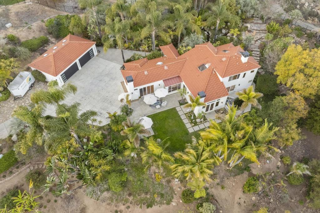 an aerial view of a house with swimming pool and outdoor space