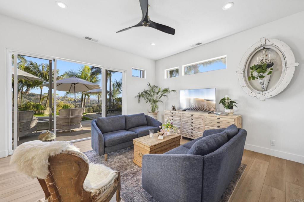 3443 Country Road Fallbrook, CA 92028 - Photo 17 of 71 a living room with furniture a fireplace and a chandelier
