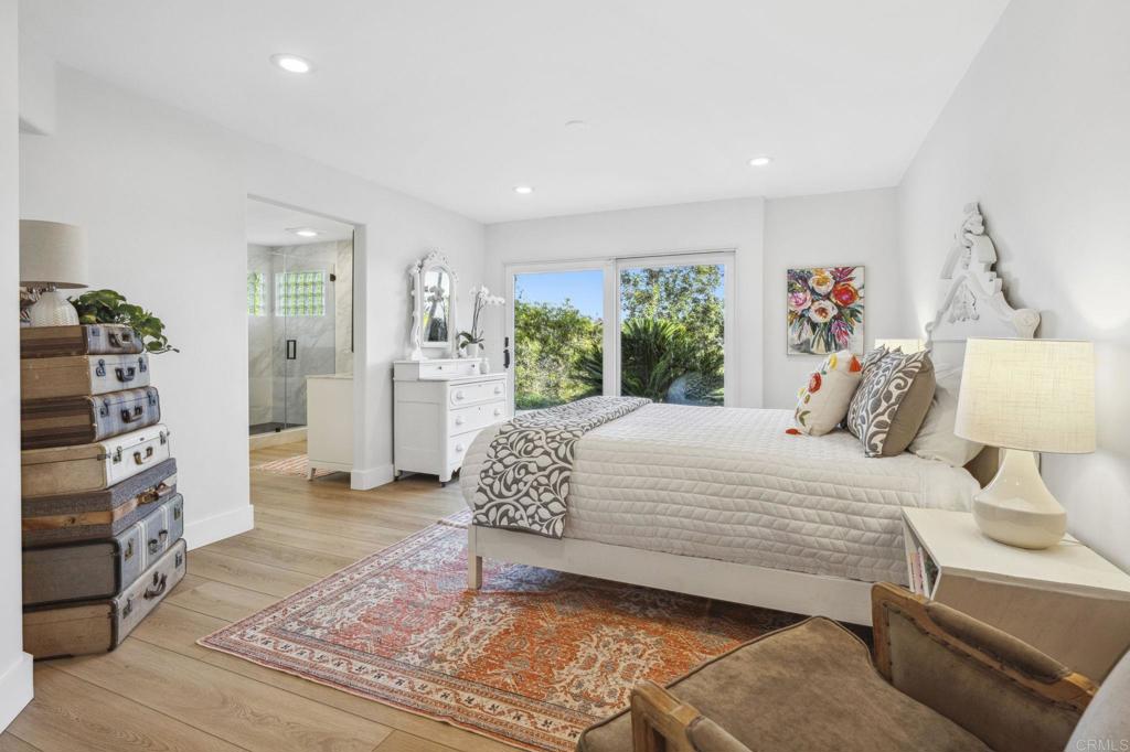 3443 Country Road Fallbrook, CA 92028 - Photo 30 of 71 a bedroom with a large bed and a flat tv screen