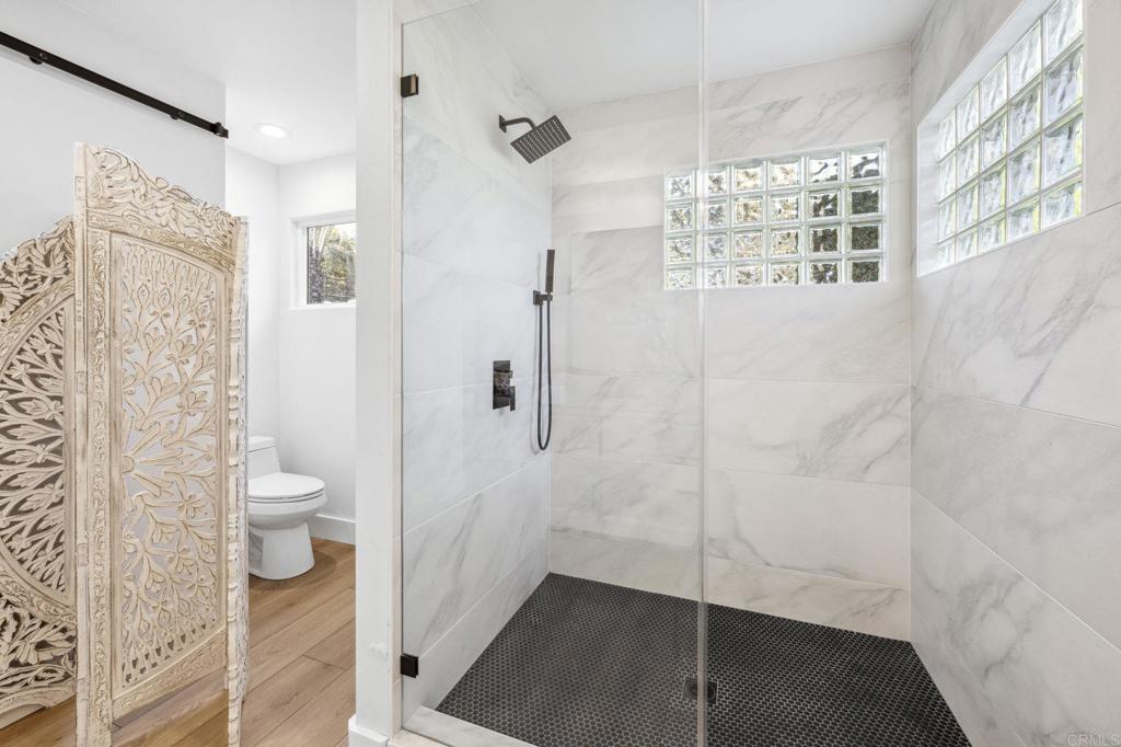 3443 Country Road Fallbrook, CA 92028 - Photo 34 of 71 a bathroom with a granite countertop shower and a toilet