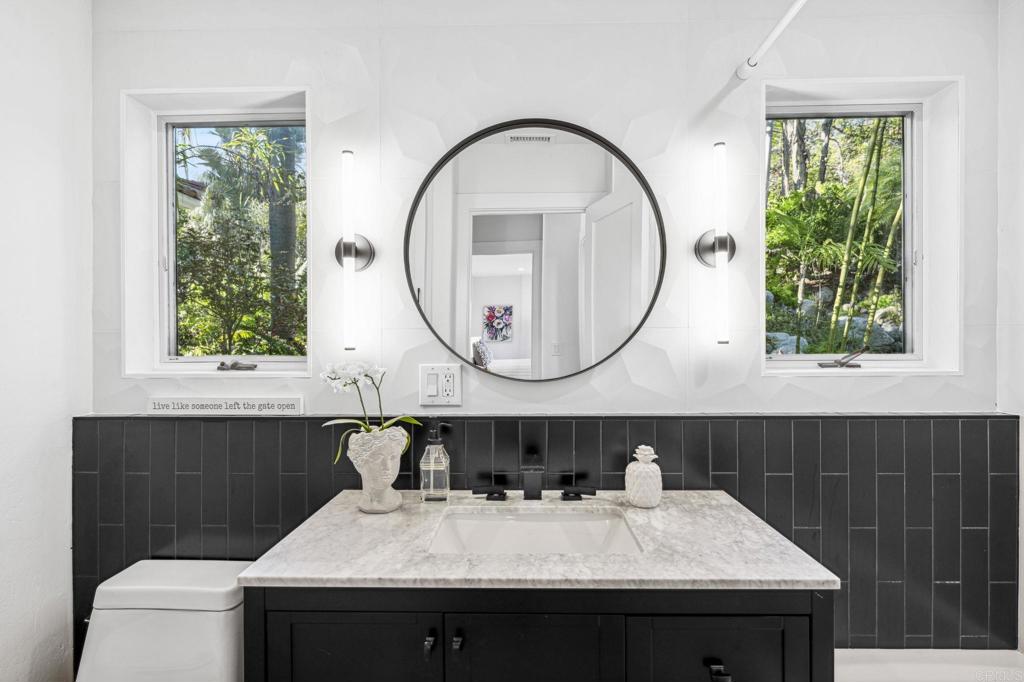 3443 Country Road Fallbrook, CA 92028 - Photo 35 of 71 a bathroom with a sink a mirror and a window