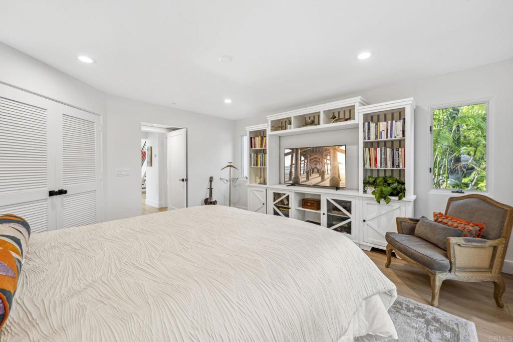 3443 Country Road Fallbrook, CA 92028 - Photo 39 of 71 a spacious bedroom with a bed a couch and a window