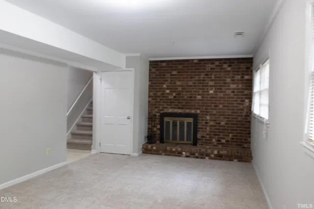 a view of an empty room with a fireplace