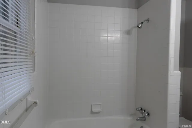 a view of a house with backyard and trees