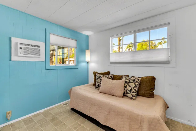 a bedroom with a bed and a table in it