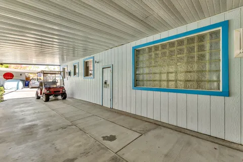 a bedroom with a large bed and a painting on the wall