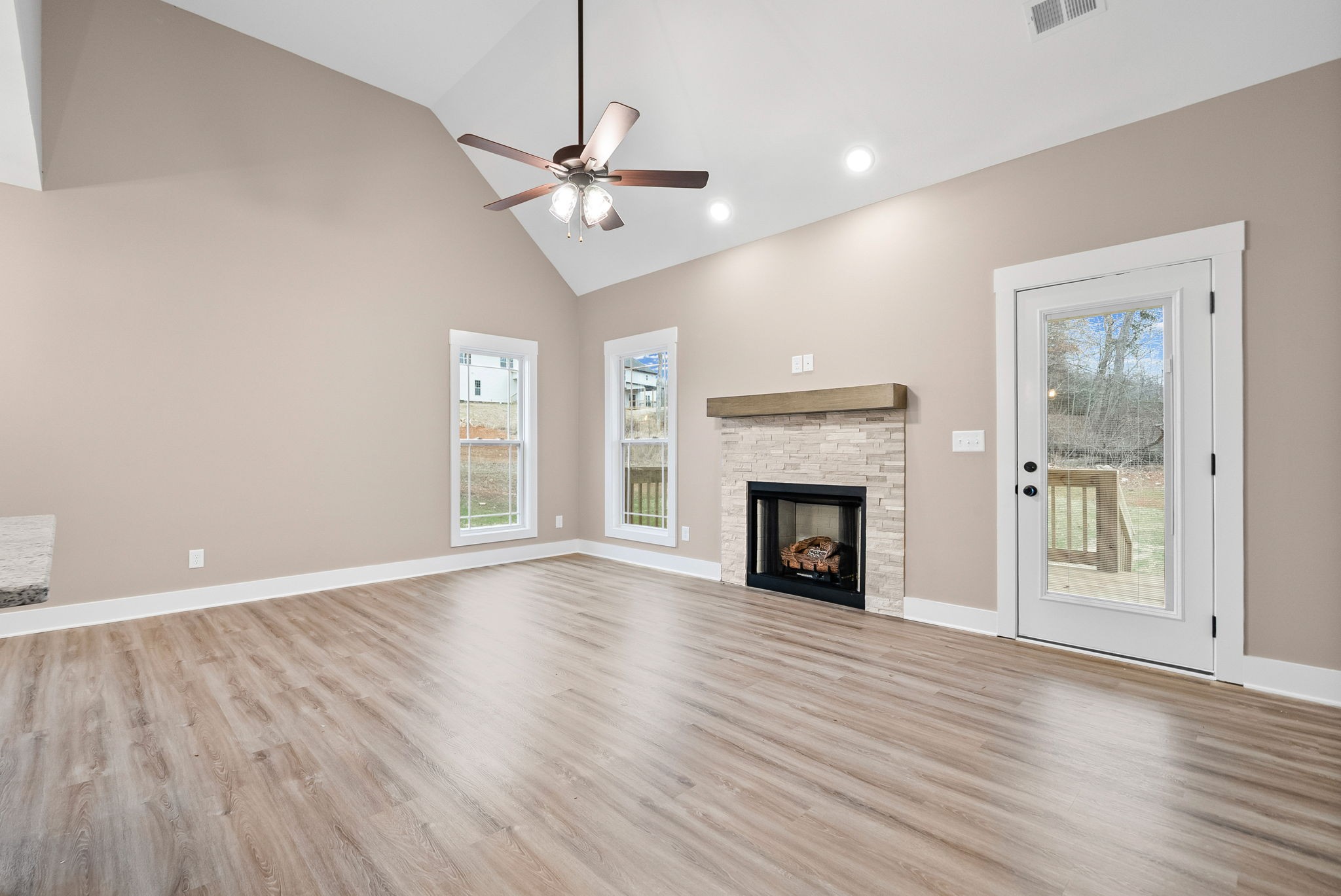 369 Timber Springs Clarksville, TN 37042 - Photo 4 of 23 a view of an empty room with wooden floor fireplace and a window
