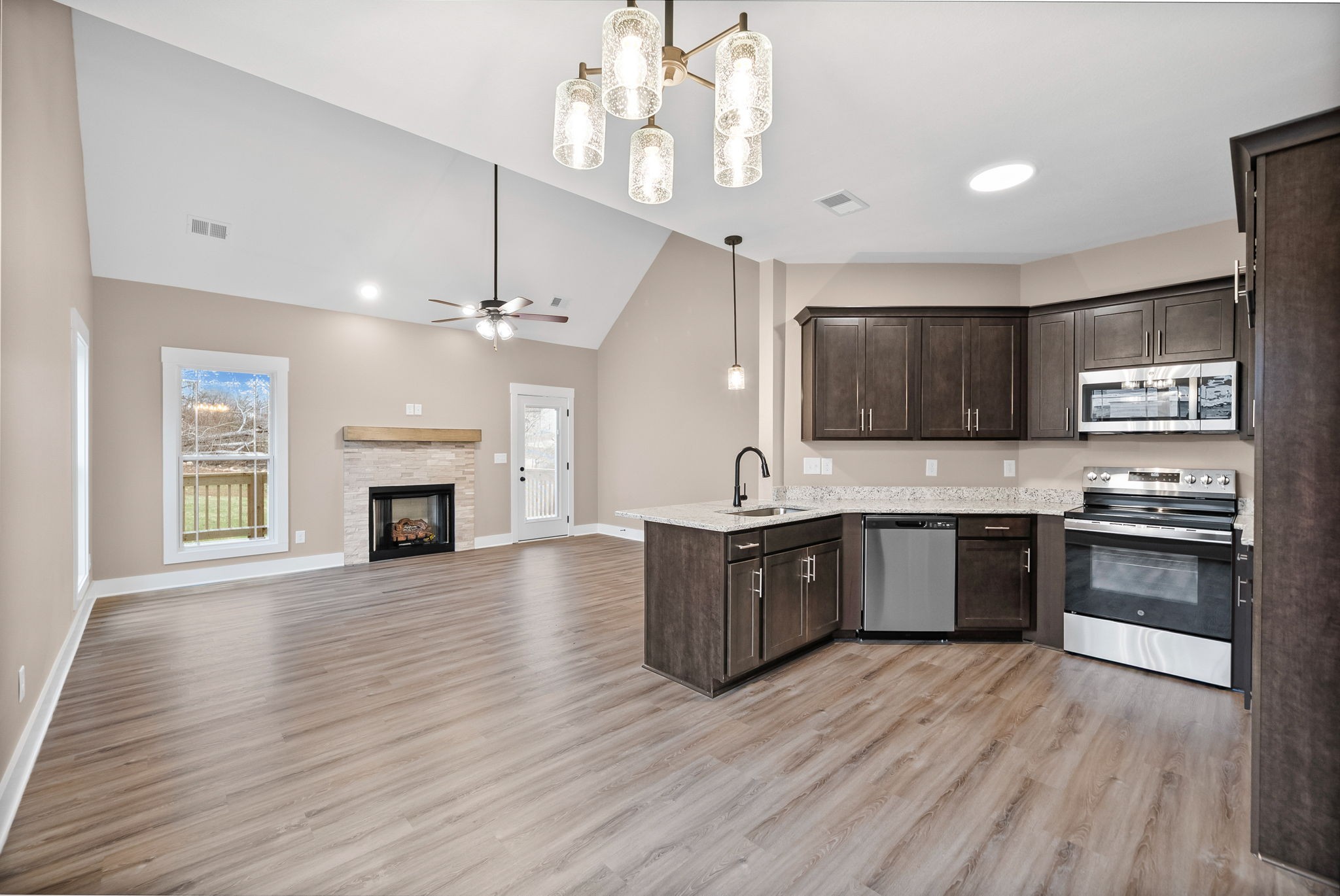 369 Timber Springs Clarksville, TN 37042 - Photo 6 of 23 a large kitchen with granite countertop a stove top oven a sink dishwasher a dining table and chairs with wooden floor