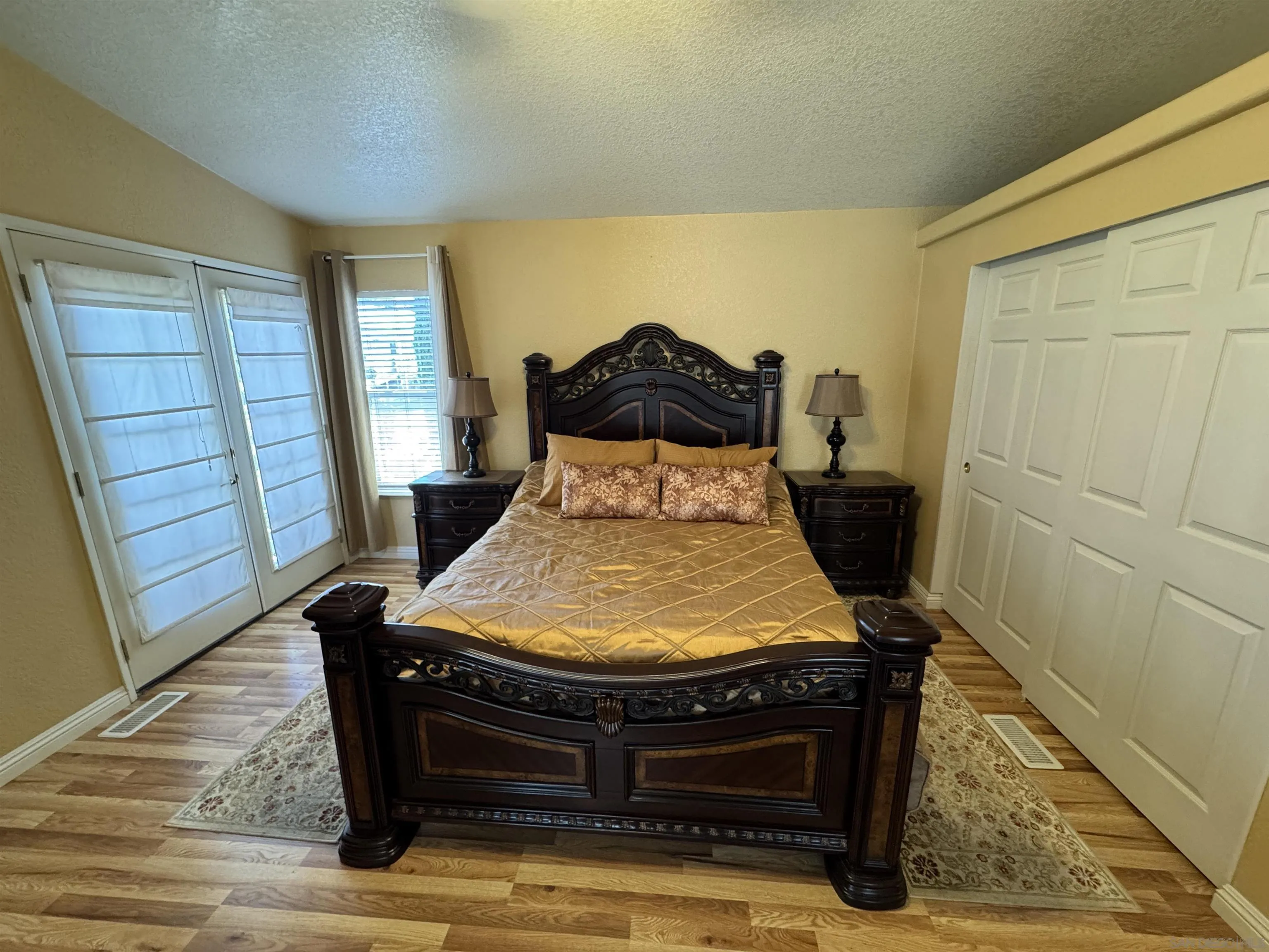 12250 Vista Del Cajon Road, Unit 25 El Cajon, CA 92021 - Photo 14 of 39 a bed sitting in a bedroom next to a window