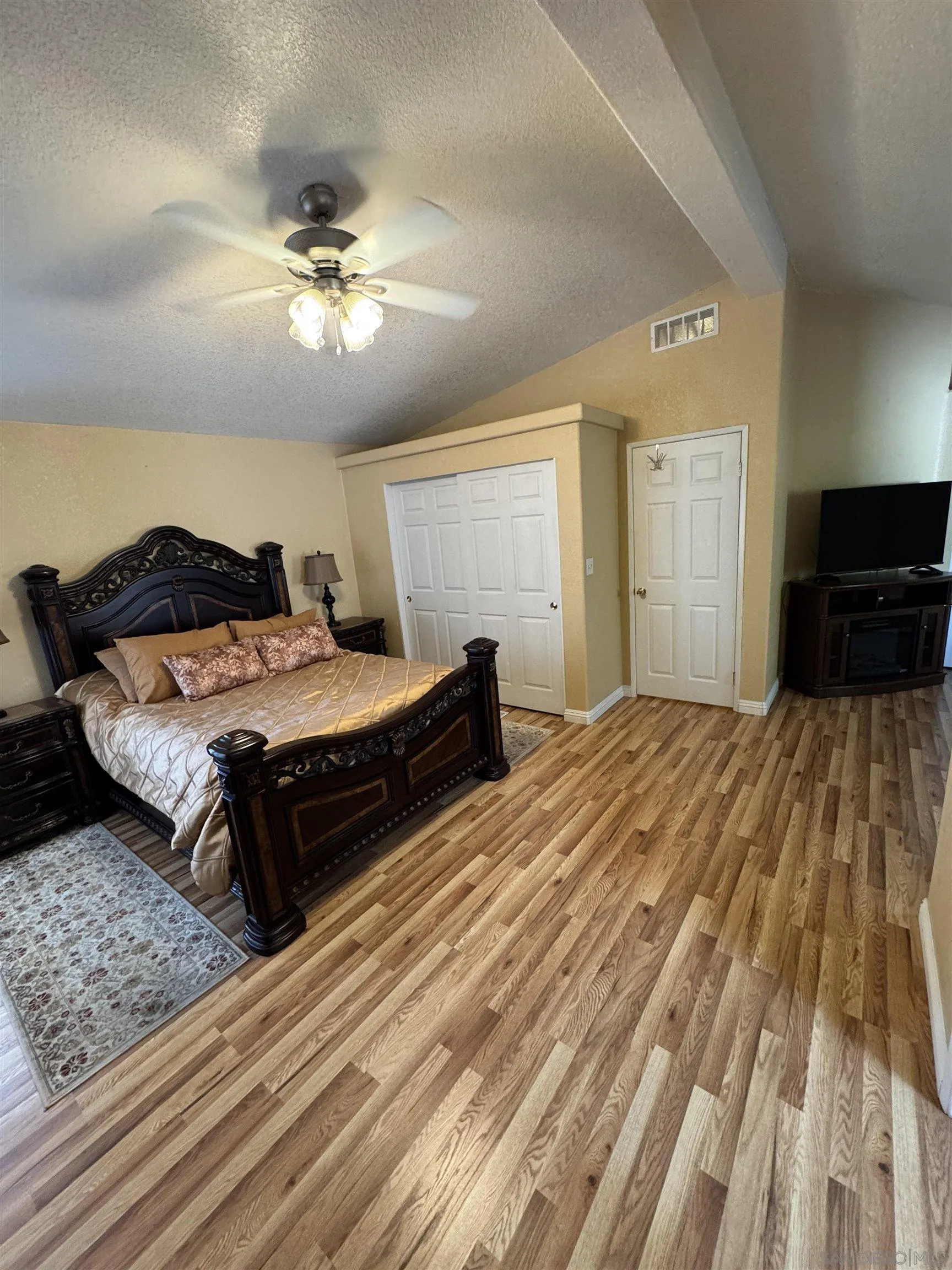 12250 Vista Del Cajon Road, Unit 25 El Cajon, CA 92021 - Photo 15 of 39 a bedroom with a bed and wooden floor
