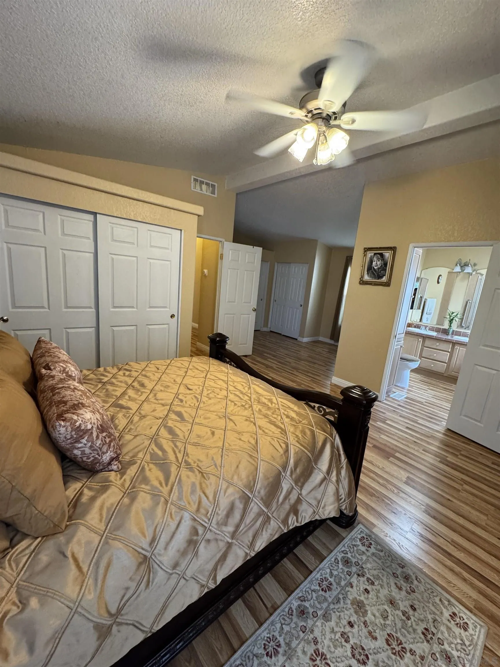 12250 Vista Del Cajon Road, Unit 25 El Cajon, CA 92021 - Photo 18 of 39 a bedroom with a large bed and a chandelier